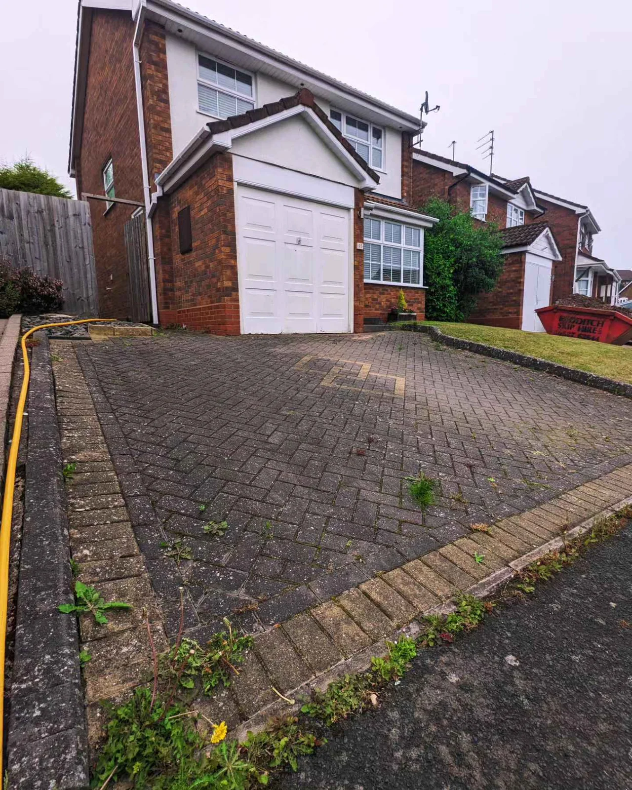 Dark block paving driveway before cleaning